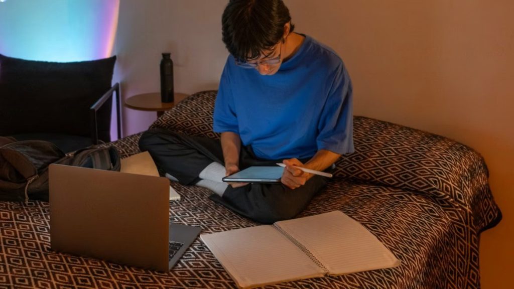 a college student studying on bed