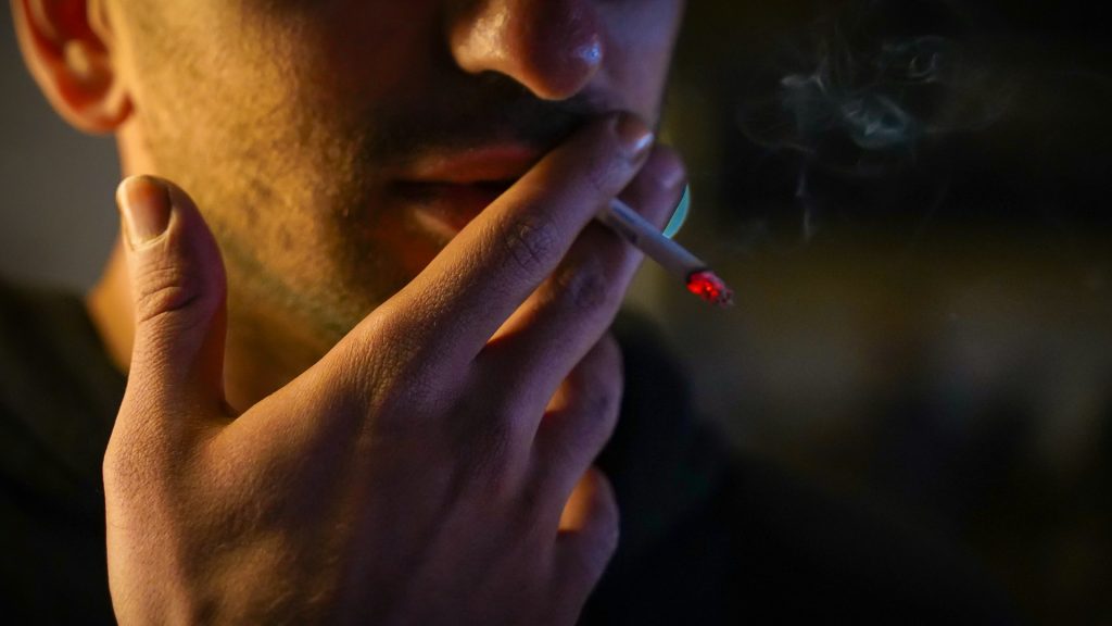 man-smoking in dark